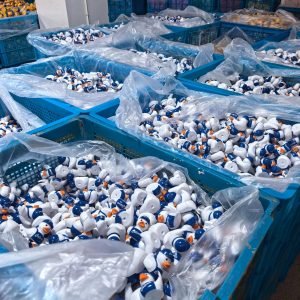 Large bins of white Culver’s ducks in factory