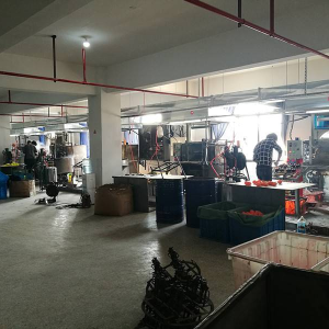 Workers operating rubber duck molding machines